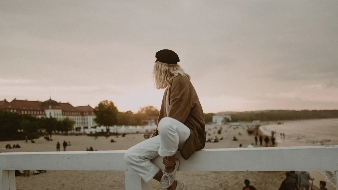 Close up on a plate of mashed potatoes, topped with baked pork chops with cream of mushroom soup, and a side of green beans.
