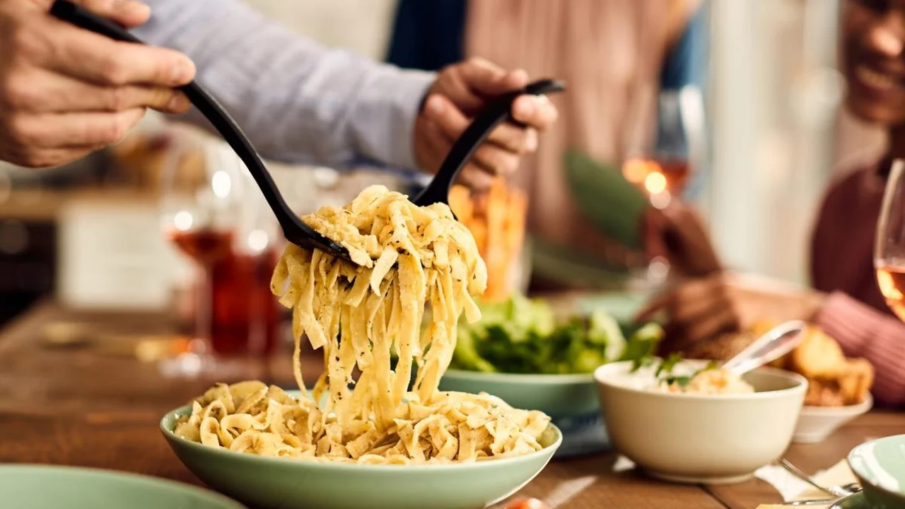 Close up on a plate of mashed potatoes, topped with baked pork chops with cream of mushroom soup, and a side of green beans.