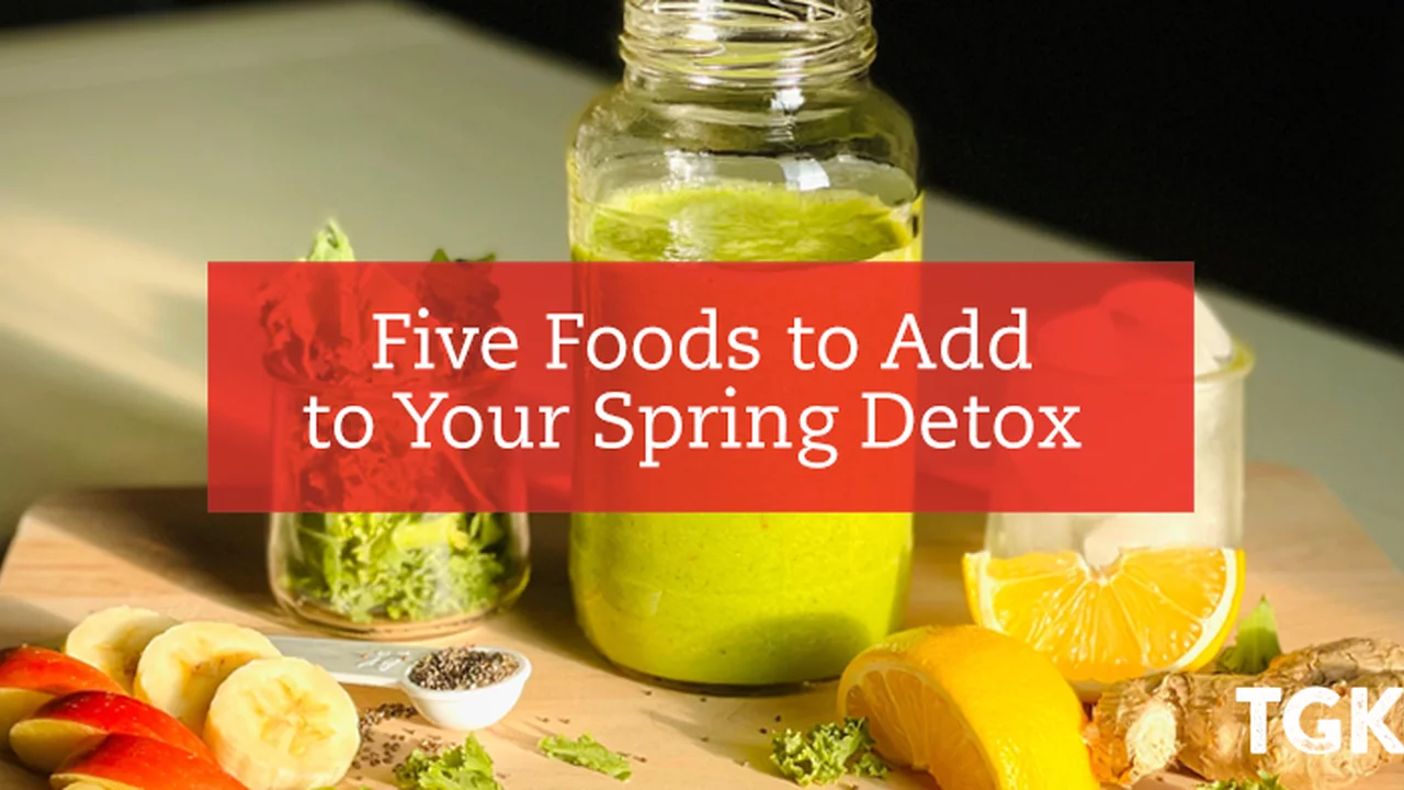 blue bowl of black bean beef tortilla soup on a board with cilantro and shredded cheese in background