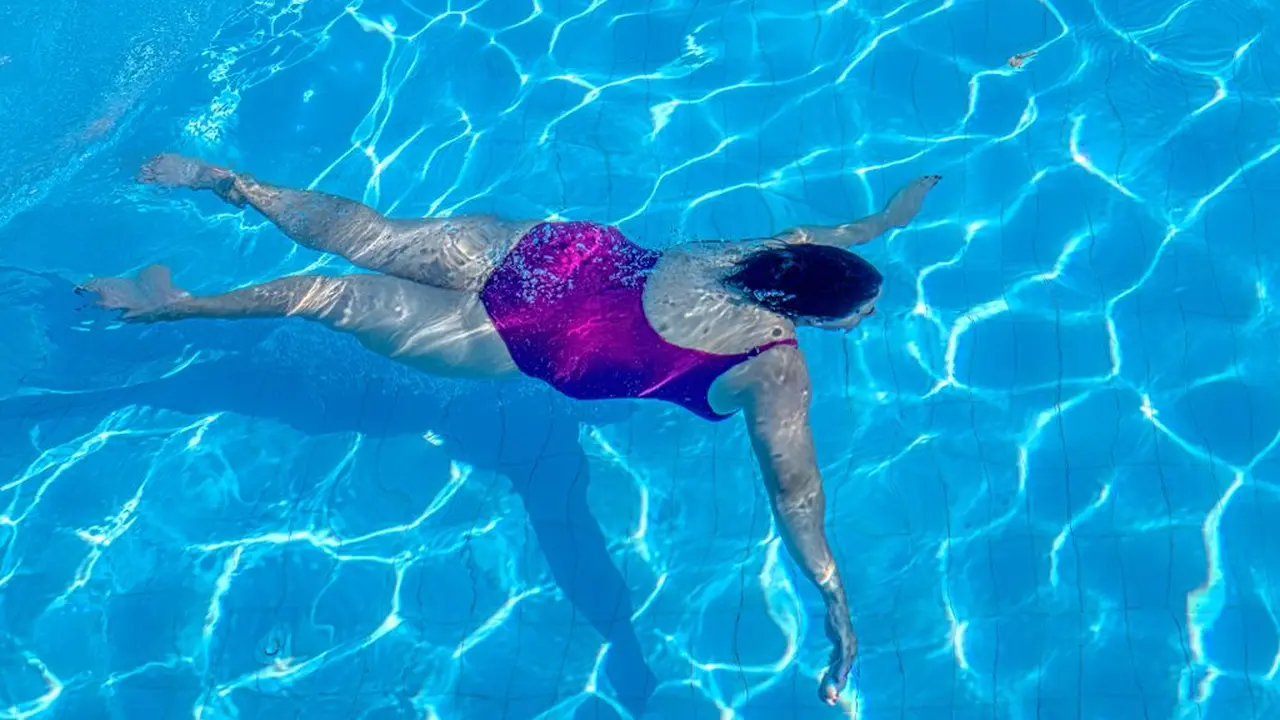 Two mint chocolate milkshakes with whipped cream and green sprinkles.