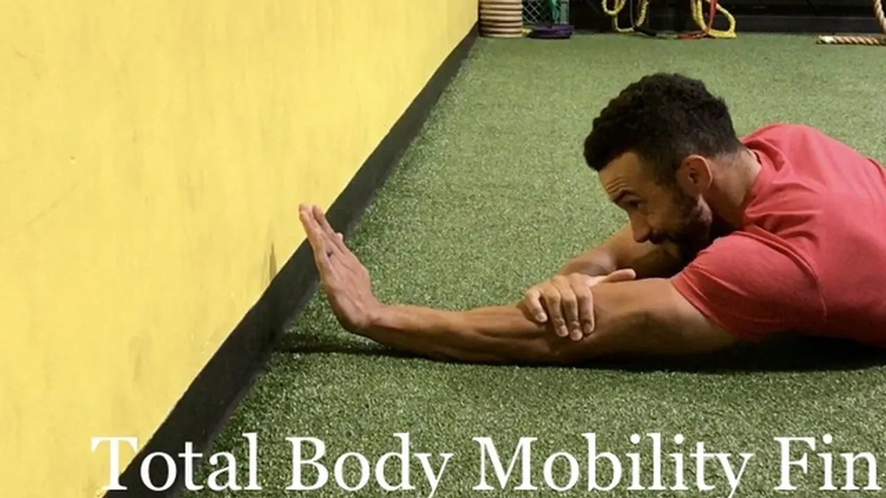 blue bowl of black bean beef tortilla soup on a board with cilantro and shredded cheese in background