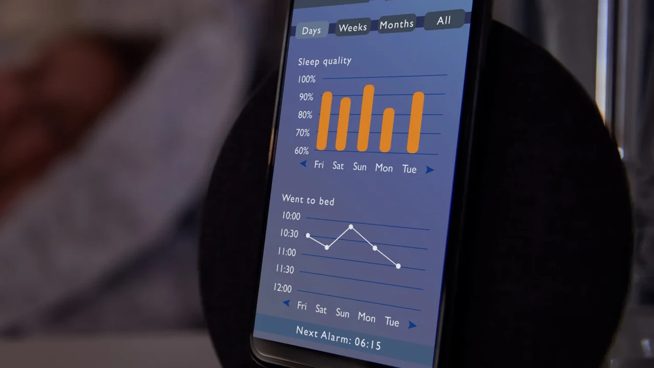Close up on a plate of mashed potatoes, topped with baked pork chops with cream of mushroom soup, and a side of green beans.